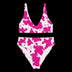 Pink cow print high-waisted bikini top and bottom laid flat showing pattern detail perfect for summer vacation outfits and festival pool parties with unique animal print style for photos