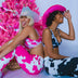 Women wearing pink and cow print bikinis at summer bachelorette party showing group outfit coordination for beach celebrations and themed pool parties with animal print fashion for photos