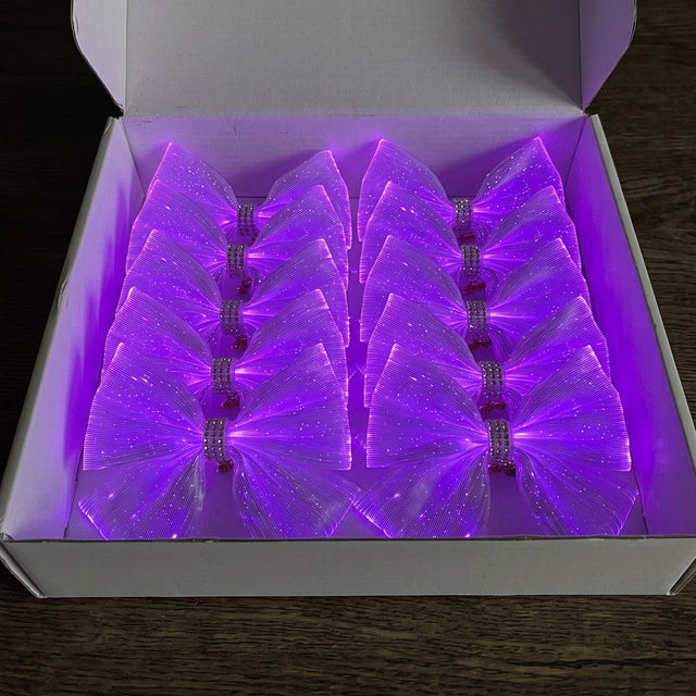 Team pack of 10 light-up cheer bows glowing purple in an open shipping box
