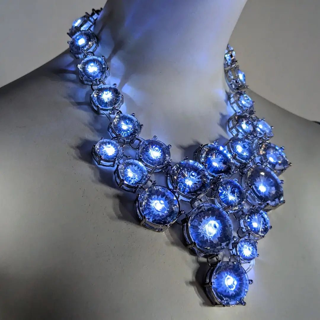 Close-up of silver white glowing rhinestone necklace showing detailed light up crystal design perfect for brides prom night and special occasion jewelry that stands out