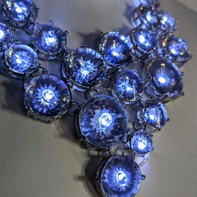 Detailed view of illuminated white rhinestone clusters featuring brilliant LED technology ideal for evening gala events and luxury party accessories with multiple light settings