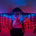 LED Fringe Gloves lit up in blue and red — opera-length light-up gloves with glowing LED fringe down the arms, worn for raves, festivals and performances.