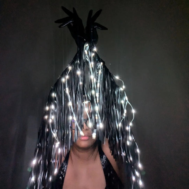 LED Fringe Gloves worn with glowing white light-up fringe cascading down — opera-length color-changing rave gloves shown lit up for stage and festival performers.