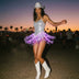 LED Fringe Sequin Dress by Neon Cowboys, a woman dancing at a festival at sunset in a silver light up sequin fringe dress glowing purple with a white cowboy hat and boots, this space cowgirl led fringe sequin dress, led dress and light up dress with a led bodysuit base is showgirl, go-go dancer and drag stagewear for raves, EDM concerts, festivals and bachelorette parties, Neon Cowboys