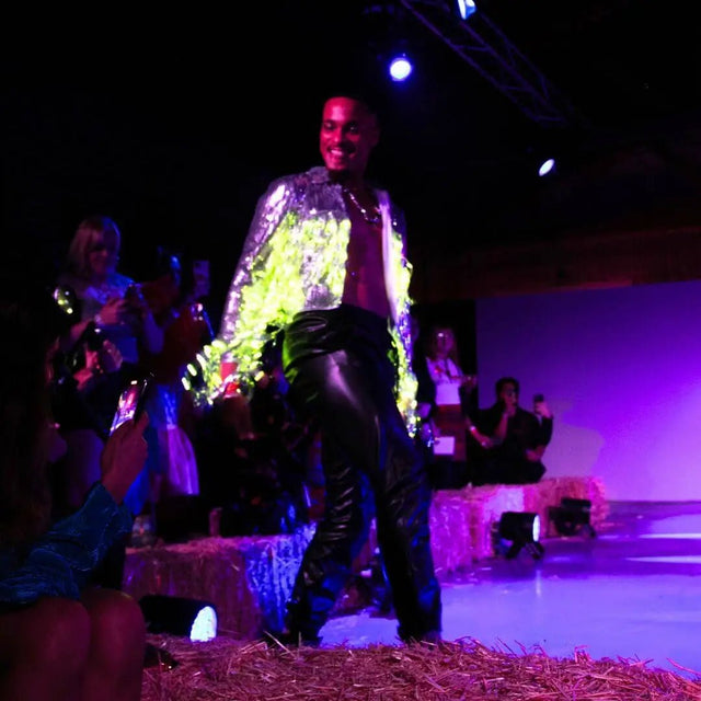 Man wearing colorful LED sequin fringe jacket on stage - Performance featuring illuminated sequin apparel under stage lighting, LGBTQIA+ demonstrating dramatic effect for entertainment industry use