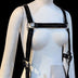 Product detail of black leather LED harness straps showing construction and fit on mannequin ideal for layering over basic clothing for unique statement pieces