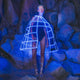 Woman wearing light up glowing blue LED hoop cage skirt structure against rock background perfect for avant garde fashion shows and futuristic festival outfits