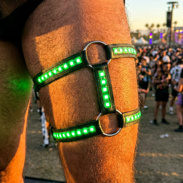 LED leg thigh harness lit green, worn at a festival