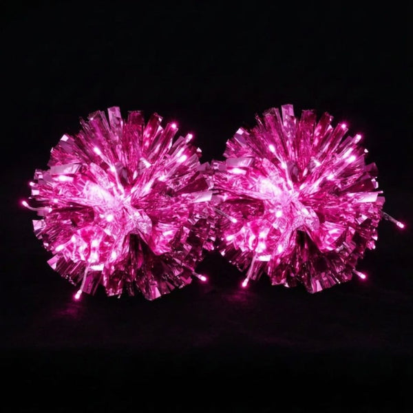 Hot pink light-up LED pom poms glowing with the lights on — metallic cheer, dance & majorette team pom poms