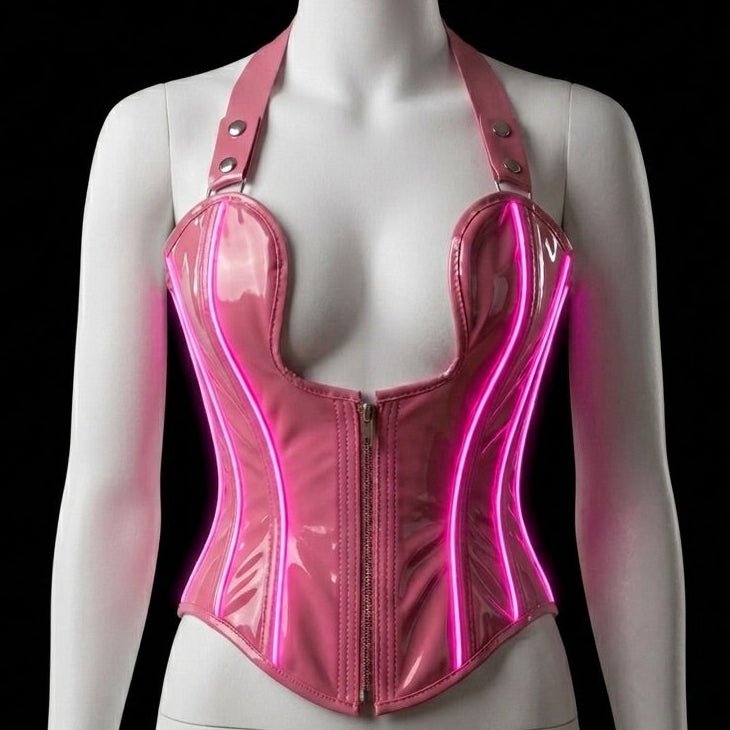Neon Cowboys pink LED light-up PVC halter corset glowing with hot pink neon piping LED wires down the front on a mannequin, made-to-order light up corset stagewear for go-go dancers, burlesque performers and drag showgirls at raves, EDM festivals and nightclub performances, Neon Cowboys