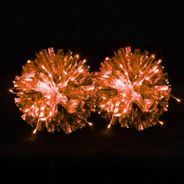 Orange light-up LED pom poms glowing — custom metallic cheer, dance & pom squad pom poms