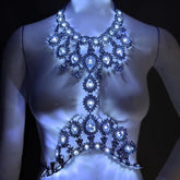 Neon Cowboys multicolor LED rhinestone body chain on a mannequin, a crystal teardrop harness glowing bright white, illuminated crystal light up body chain stagewear for go-go dancers, burlesque performers and showgirls at raves, EDM festivals and Cleopatra-inspired costumes, Neon Cowboys