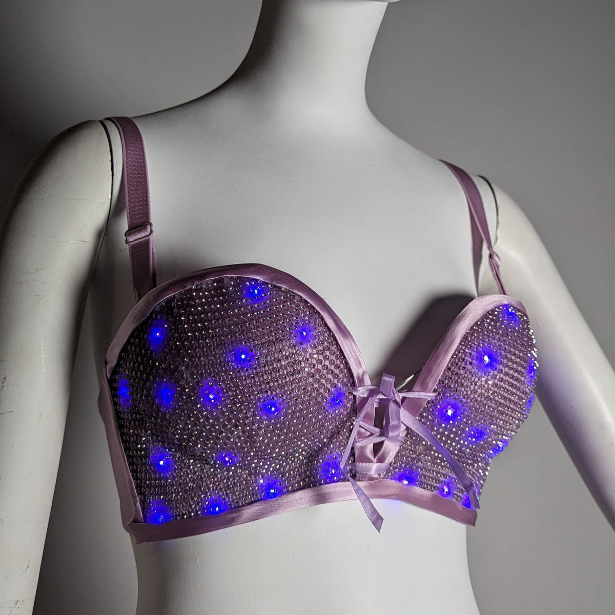 Purple LED light up bra on woman with glowing sequin pattern ideal for festival season outfit statement pieces and electric dance music events