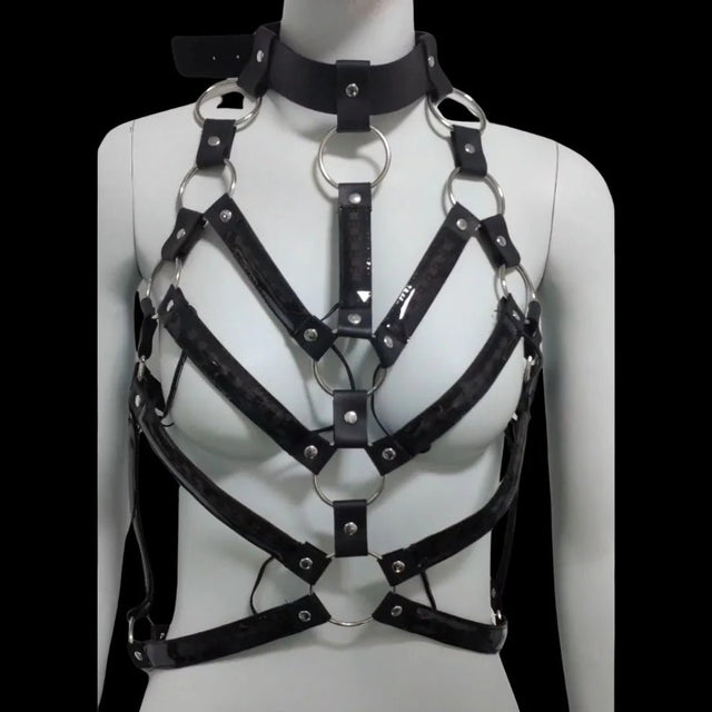 LED Rib Cage Harness with lights off — black patent rib-cage-style body harness with silver O-rings and choker collar, a made-to-order cage harness for rave, burlesque and stage.