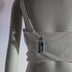 A side view of the white rose corset showing the clear removable AA battery pack that powers the LED roses, a light up corset and LED rose corset stagewear for go-go dancers, burlesque performers and festival dancers at raves, music festivals, and EDM concerts, Neon Cowboys LED rose corset, Neon Cowboys