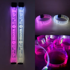 Pink and blue light up WANTED LED chokers glowing vibrantly at nightclub rave party accessories collection for music festivals and nighttime events that enhance any outfit with unique glow