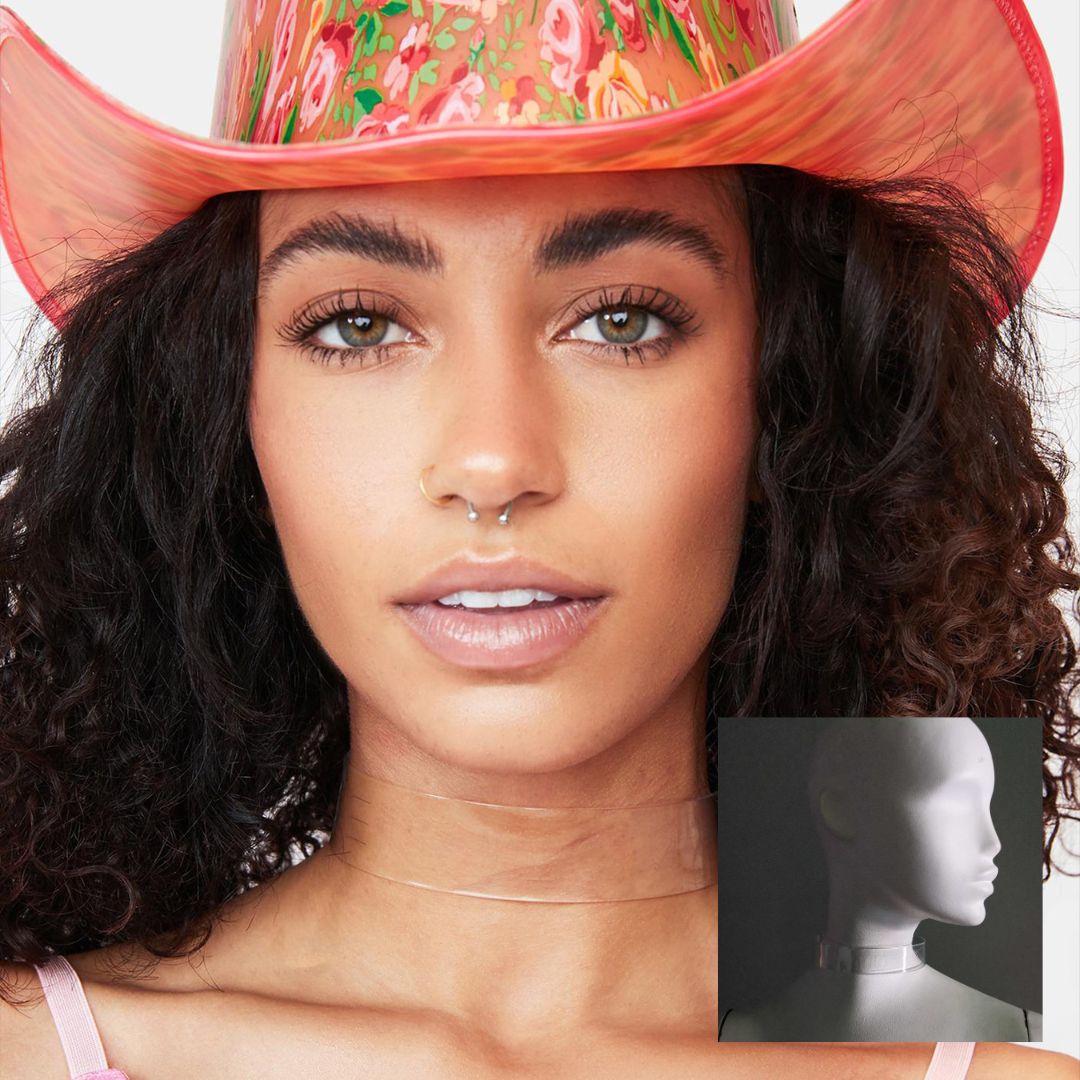 Woman with curly hair wearing pink cowboy hat and light up WANTED choker for country western themed bachelorette party outfit that combines festival fashion with fun glowing accessories