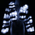 Zebra faux fur crop jacket glowing bright white LED stripes on a mannequin in the dark, a light up festival coat and led jacket couture piece for burlesque and drag stagewear, dazzling at raves, Burning Man and music festivals, Neon Cowboys