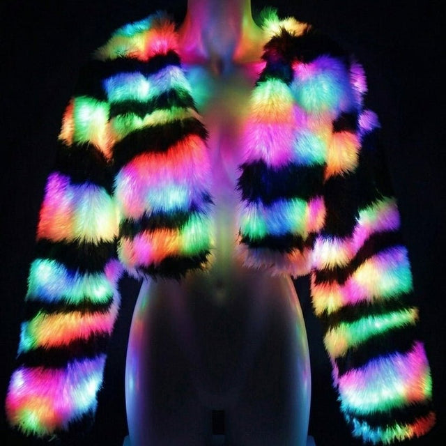 Rainbow LED zebra stripe faux fur crop jacket glowing on a mannequin against black, a color-changing light up coat and led jacket couture piece for burlesque performers, drag and festival stagewear at raves, EDC and music festivals, Neon Cowboys