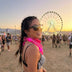 Woman in sunglasses at a festival at sunset wearing a pink glowing LED light-up bandana, neon bandana and led bandana for a rave, music festival or country concert, glow cowgirl accessory, Neon Cowboys