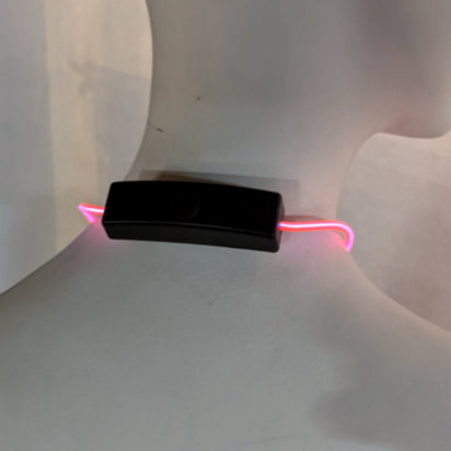 Close up of pink light up bolo tie battery pack showing compact design and easy operation for convenient wearable lighting technology