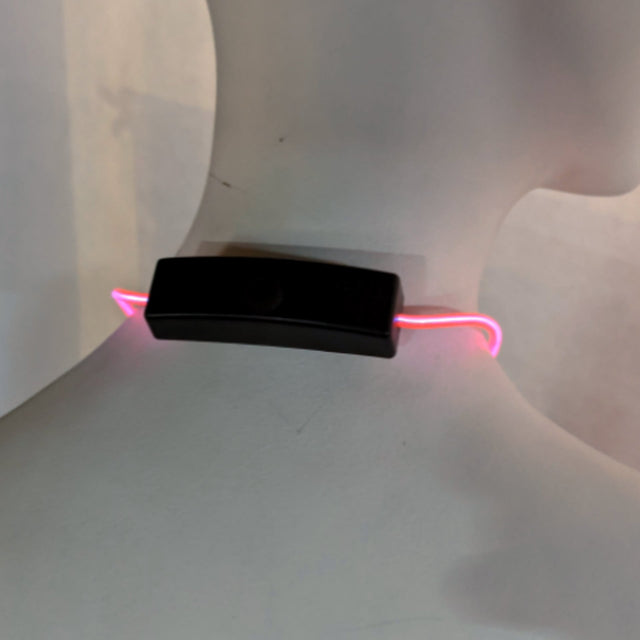 Close up of pink light up bolo tie battery pack showing compact design and easy operation for convenient wearable lighting technology