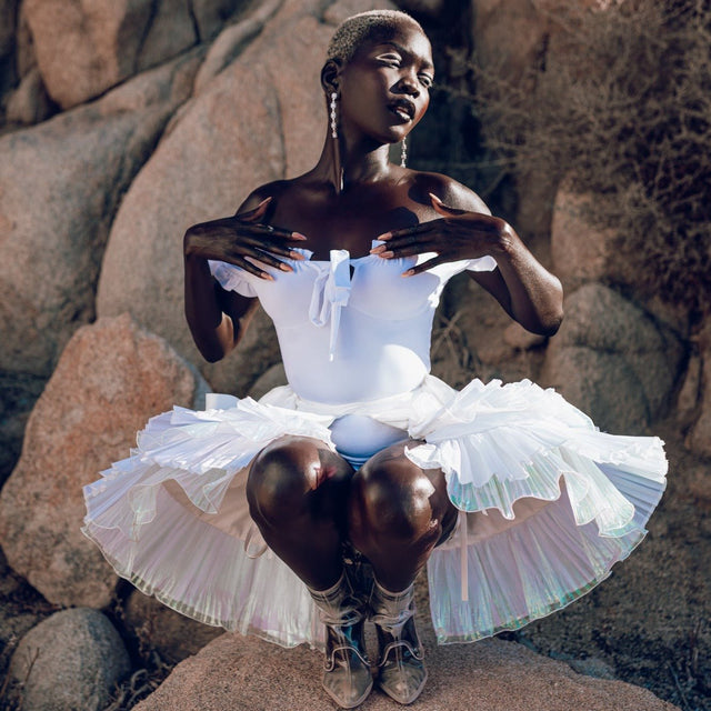 Stunning model wearing white illuminated bustle skirt showing layered design perfect for theatrical performances and futuristic costume parties