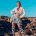 Woman in desert setting wearing light up western outfit with blue gingham skirt showcasing versatile styling for outdoor music festivals and ranch parties
