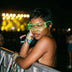 Woman in green glowing LED cyber glasses at a night music festival stage, futuristic light up glasses and space glasses for raves, EDM concerts, Coachella, EDC, and Pride, Neon Cowboys
