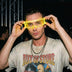 Man lifting yellow glowing LED cyber glasses at a nightclub concert, futuristic light up glasses and cyberpunk led glasses for raves, music festivals, EDM concerts, nightlife, and Halloween costumes, Neon Cowboys