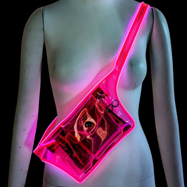 Woman wearing pink illuminated fanny pack with clear transparent pouch perfect for music festivals stadium events and nightclub accessories