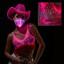 Woman wearing pink light up fringe bralette with matching face mask showcasing coordinated western outfit for night time edc music festivals and space cowgirl halloween costumes