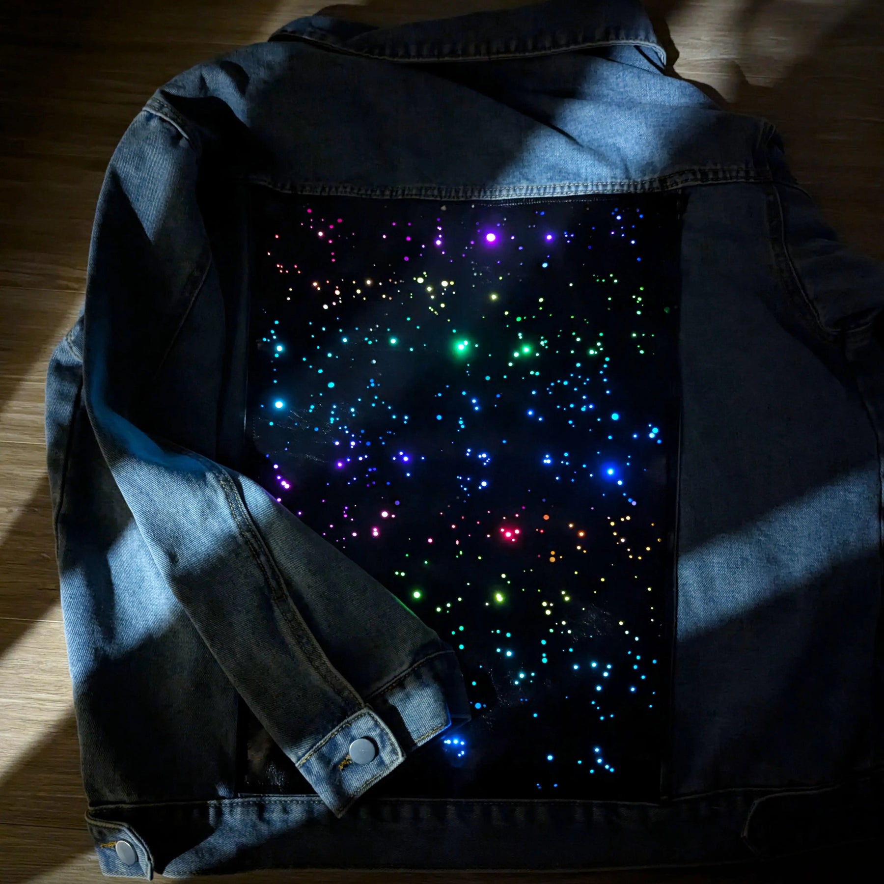 Galaxy Denim Jacket Lighting Effect Detail - Close-Up of LED Light Pattern - Color Changing Jean Jacket for Concerts and Parties - Neon Wearable Fashion Technology