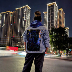 Light Up LED Space Galaxy Jacket Street Style - Woman Wearing LED Denim Jacket in Urban Setting - Tron Lightcycle 2025 Night Apparel Outfit - Night Out Fashion with City Backdrop Las Vegas
