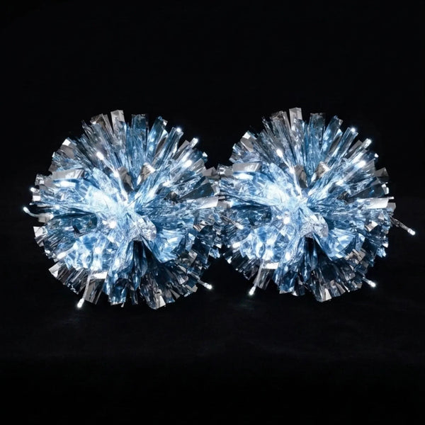 Glowing silver LED light-up pom poms lit in the dark — a rechargeable, remote-controlled color-changing pair of cheerleading pom poms for game day and dance.