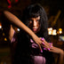 Model posing at a night carnival with pink glowing LED light-up press-on nails, wireless rave nails and led press on nails that light up for a music festival, EDC or bachelorette, Neon Cowboys rave nails