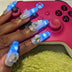 Woman in a white fringe jacket framing her face with glowing LED light-up press-on nails, wireless led nails and light up nails accessory for a rave, music festival or disco cowgirl look, Neon Cowboys