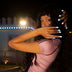 Model covering her smile with white glowing LED light-up press-on nails at a lit-up fair, wireless led nails and light up press on nails for a rave, bachelorette or EDM concert, Neon Cowboys