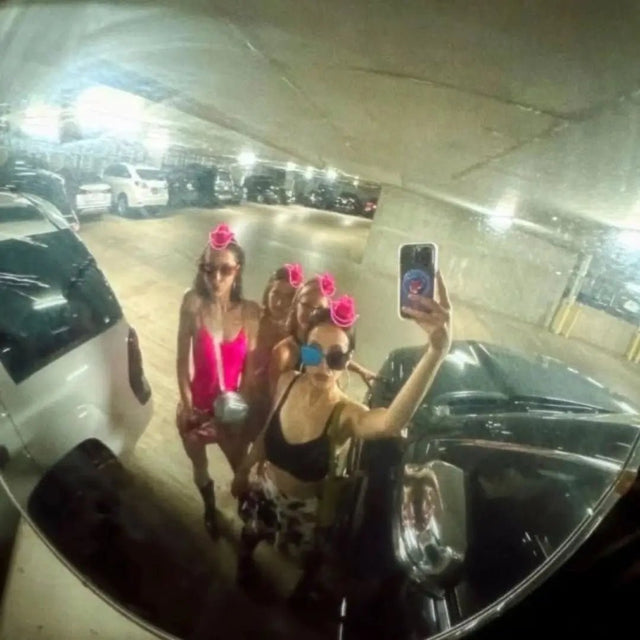 Group of women in glowing pink LED light-up mini cowboy hats taking a mirror selfie in a parking garage, matching neon cowgirl hats and space cowgirl accessories for bachelorette parties, raves, music festivals and Vegas nights, Neon Cowboys