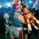 Music lover at electronic festival wearing pink mini neon cowboys hat perfect for Tomorrowland Ultra Music Festival and outdoor concert photography