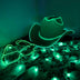 Green LED cowboy hat with light-up pattern across fabric - Bright emerald Neon Cowboy hat with detailed illumination pattern for nighttime events