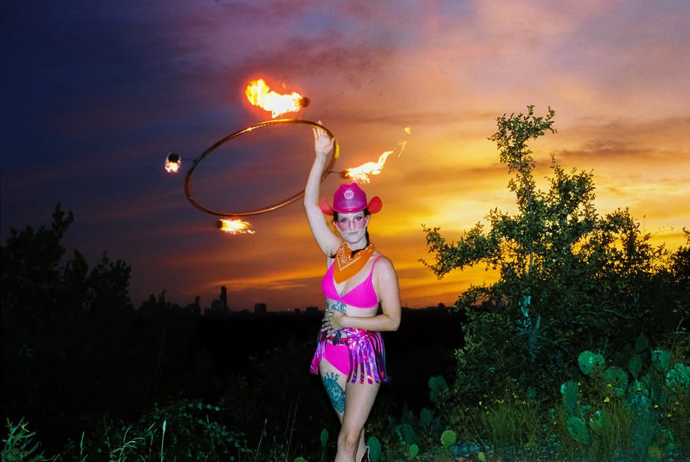 Fire performer in Neon Cowboys LED light-up stagewear, Austin