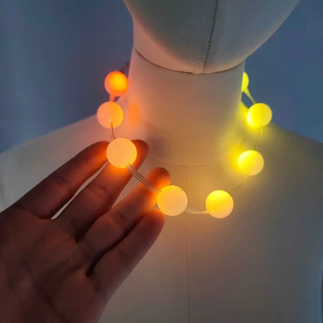 Orange LED Beaded Necklace in Hand - Yellow Glowing Sphere Necklace - Bulk Party Favors for Las Vegas Events and Music Festivals in any city - Light up Ball Choker Jewelry 