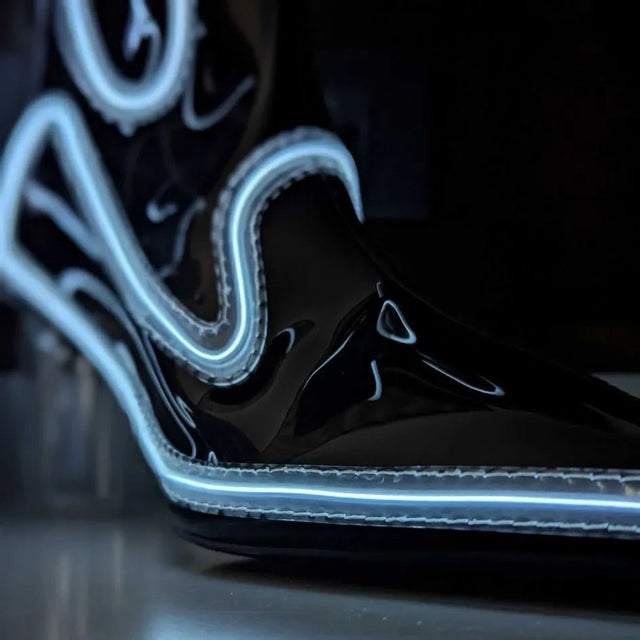A close-up of a black light up boot pointed toe with a bright white glowing outline, this Out Past Midnight light up cowgirl boot and light up heel is made for raves, festivals and evening events, Neon Cowboys
