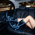 A woman reclining in a moving car at night with legs up in blue glowing LED light up boots, these Out Past Midnight light up cowboy boots and light up heels are made for raves, Vegas nights and bachelorette parties, Neon Cowboys