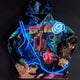 Close-up of animated Neon Cowboys hoodie design showing glowing blue and pink graphics ideal for rave outfits and festival fashion statements