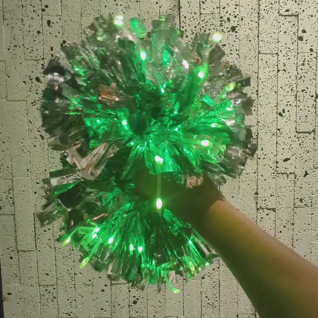 LED light-up pom poms in action — remote-controlled color-changing glow pom poms waved through a routine, custom team pom poms for cheer, dance teams and performances.