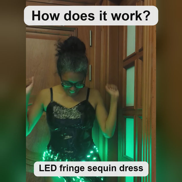 How the LED Fringe Sequin Dress works: the black sequin dress worn at night, its rechargeable USB battery pack, the remote picking one solid color or cycling colors, shown in black and silver sequins — Neon Cowboys