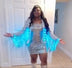 Woman wearing silver LED sequin fringe jacket with dress in doorway video - Styling demonstration of illuminated sequin apparel for Renaissance World Tour, nightclub appearances, and special events