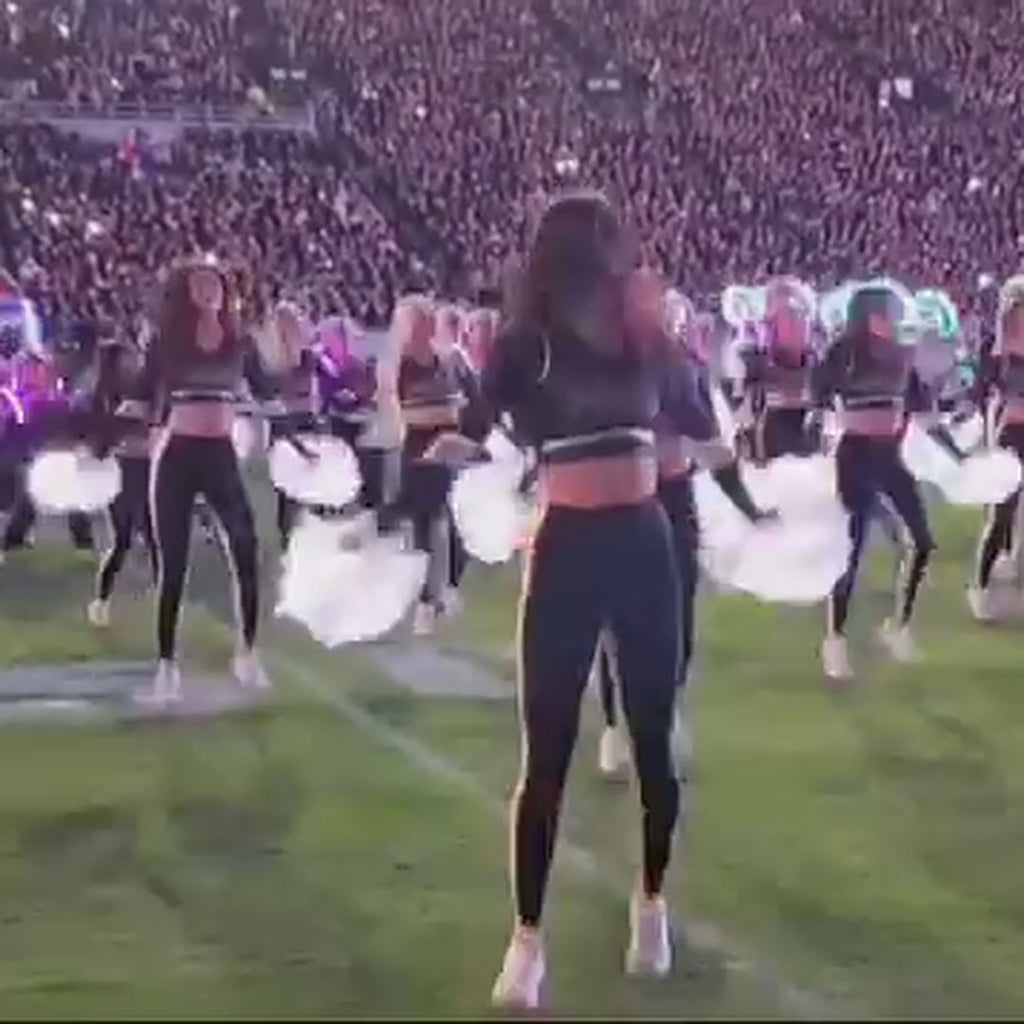 Fan video from the stands: Purdue's dancers performing at a night football game with Neon Cowboys light-up LED pom poms that switch from white to green, blue and pink mid-routine